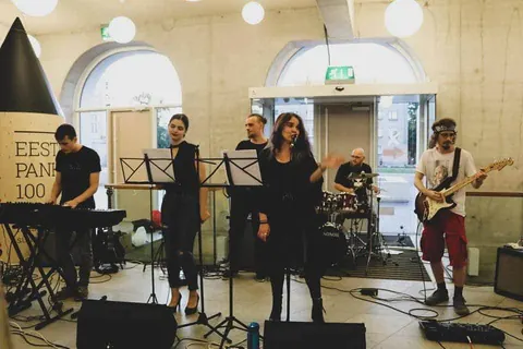 Daylight in a hall with arched windows, the band around music stands